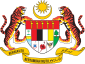 Shield showing the symbols of the Malaysian states with a star and crescent above it and a motto below it supported by two tigers