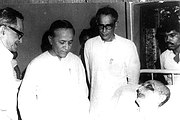 B. T. Ranadive, Jyoti Basu and Hare Krishna Konar standing in front of Muzaffar Ahmad at his last breath