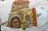 Fragment of a wall painting with a man's head and an Old South Arabian inscription, probably a banquet scene (1st/2nd century AD)