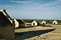 Image 25The forced African migrants brought to the Caribbean lived in inhumane conditions. Above are examples of slave huts in Dutch Bonaire. About 5 feet tall and 6 feet wide, between 2 and 3 slaves slept in these after working in nearby salt mines. (from History of the Caribbean)