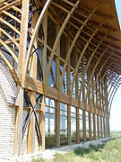 Detail: cedar beams and glass facade