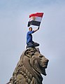Egyptian protester during the 2011 Egyptian revolution holding the Egyptian flag