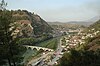 Mountain valley with river, bridge, and village