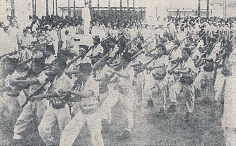 Soldiers marching around Sukarno