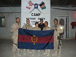 Guards holding the CGG camp flag in Kandahar