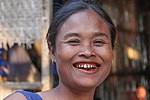 A woman in Southern Laos with the characteristic red-stained teeth and gums from chewing betel nut