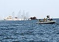 A SWCC aboard crew fires a MK-19 grenade launcher