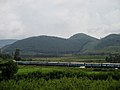 A view of a passing train in foreground and the valley in background