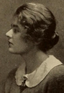 A young white woman in profile; her hair is dressed back to the nape; she is wearing a white peter-pan collar