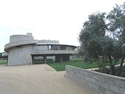 The David Wright House was built in 1951 and is located at 5212 East Exeter Boulevard, but currently has an entrance on the 4500 block of North Rubicon Avenue. The house was built in the Arcadia section of Phoenix as part of a Frank Lloyd Wright magazine story circa 1948 on how to live in the desert southwest. Both the circular design and the spiral ramps are features Wright also used in his design of the Solomon R. Guggenheim Museum. After Wright’s death in 1959, his son David and daughter-in-law Gladys lived in the home until his death in 1997 at 102 years of age and his widow, Gladys, died in 2008 at 104, outliving their only son, who died at 49 years of age. David and Gladys were the only owners of the home and lived in it their entire lives.