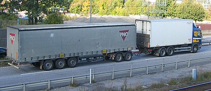 A truck pulling a semi-trailer using a trailer Dolly