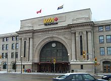 Large grey stone building with large ornamental archway entrance