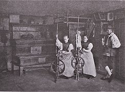 Women spinning in farmhouse