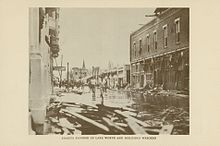 An image showing damage and flooding in a downtown setting