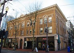 Photograph of a 3-story building on an urban street corner.