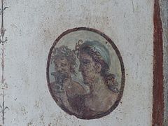 Roundel with heads of satyrs in room f