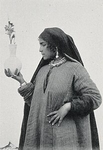 A woman selling flowers in Egypt, 1906