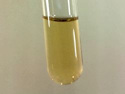 Small sample of pale yellow liquid Fluorine condensed in liquid Nitrogen