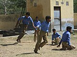 E-13. (Kabaddi, Kho Kho) Boys pick up speed in a game of kho-kho at a Government School in Haryana