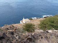 Ponta Preta Lighthouse above the nearby hill