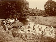 In England, boys swimming nude and girls in suits (1910)