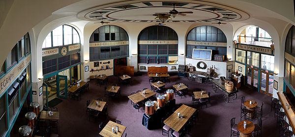 Large, octagonal room with several, square tables surrounded with chairs