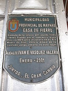Color photograph of a commemorative plaque mounted on the exterior wall of Joseph Danly's Casa de Hierro, Iquitos, Peru, taken in February 2011