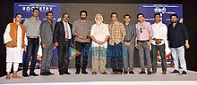 A photo of R. Madhavan and others posing for the camera.