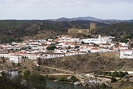 Mértola viewed from the opposite shore of the Guadiana, with the city wall and the medieval castle uphill