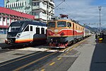 New CAF Civity next to passenger train hauled by older former JŽ class 461.