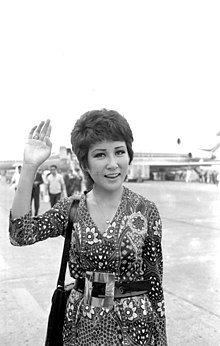 Woman waving at camera