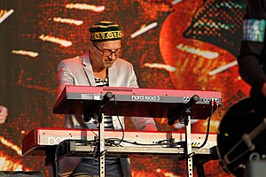 Clarence Öfwerman performing behind a bank of keyboards onstage