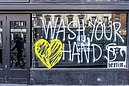 Wash your hands window in Dame Street Boarded up