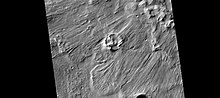 放大显示的陨坑中河道，照片右侧是被侵蚀的坑壁部分，左侧部分为坑底。