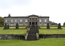 A photograph of the north face of Aberlour House, with a flight of stone steps leading to the house in the foreground