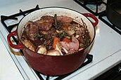 Coq au vin, a typical dish in French cuisine.