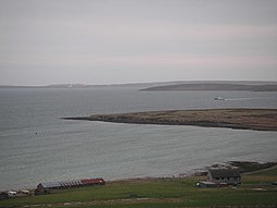 Holm of Houton offshore of Orkney Mainland, with Cava and Flotta beyond the ferry.