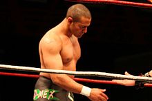 Rocky Romero posing in the ring before a match.