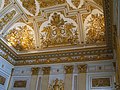 The intricate decorations on the ceiling of the palace.