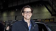 Carrey walking in to the Ed Sullivan Theater, venue for the Late Show with David Letterman, in 2010, he is on 53rd street, behind him is the Broadway Theatre (53rd Street)