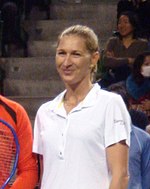 A blond-haired women wearing a white shirt