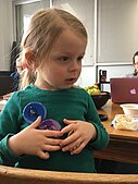 Youngest editor models Art + Feminism Buttons during the Cornell University 2017 Art + Feminism Wikipedia edit-a-thon. Fine Arts Library, March 11, 2017.