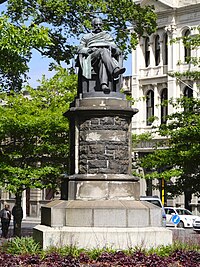 A photo of the statue surrounded by trees