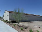 Housing Storage Supply Warehouse at Williams Air Force Base (now Arizona State University at the Polytechnic campus). The housing supply warehouse was constructed in December 1941 by Del E. Webb Construction Company. The housing supply warehouse is significant for its association with the initial development and construction at Williams Air Force Base. Listed in the National Register of Historic Places – 1995. Reference 95000746