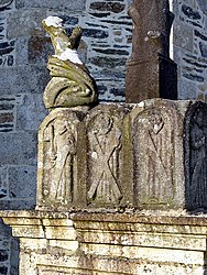 Mary Magdalene kneels in prayer at the base of the cross