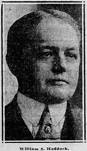 Black and white photo of a middle-aged man wearing a suit and necktie