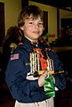 Image 27A happy Cub Scout holds a winning pine car