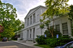 A two-story white Neoclassical school building