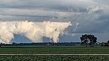Two tornadoes, seen from a distance over flat farm country