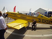 A side view showing the tandem cockpit and deflected flaps
